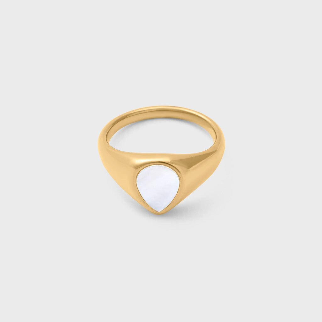 Gold ring with a MOP on a light gray background