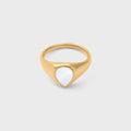 Gold ring with a MOP on a light gray background