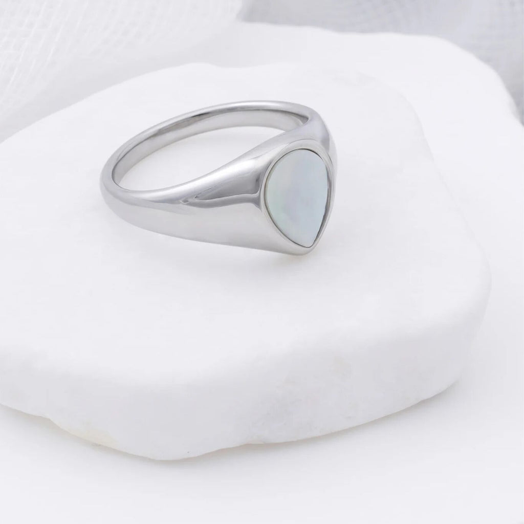 Silver ring with a teardrop MOP on a white background