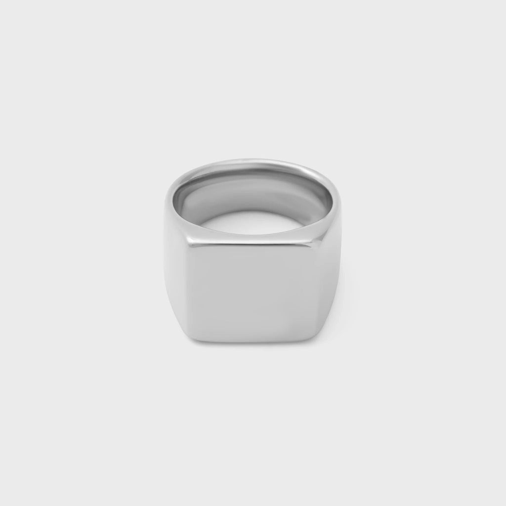 Silver square signet ring on a white background