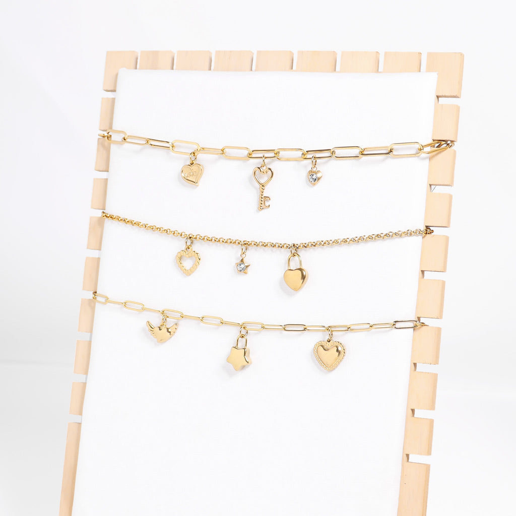 Heart With Cubic Zirconia Charm with other charms and chains on display