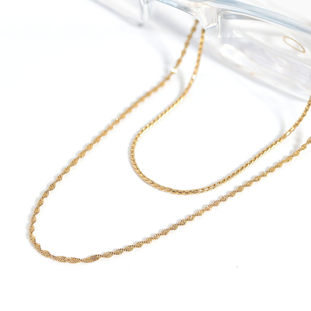 Gold chain necklace on a white background