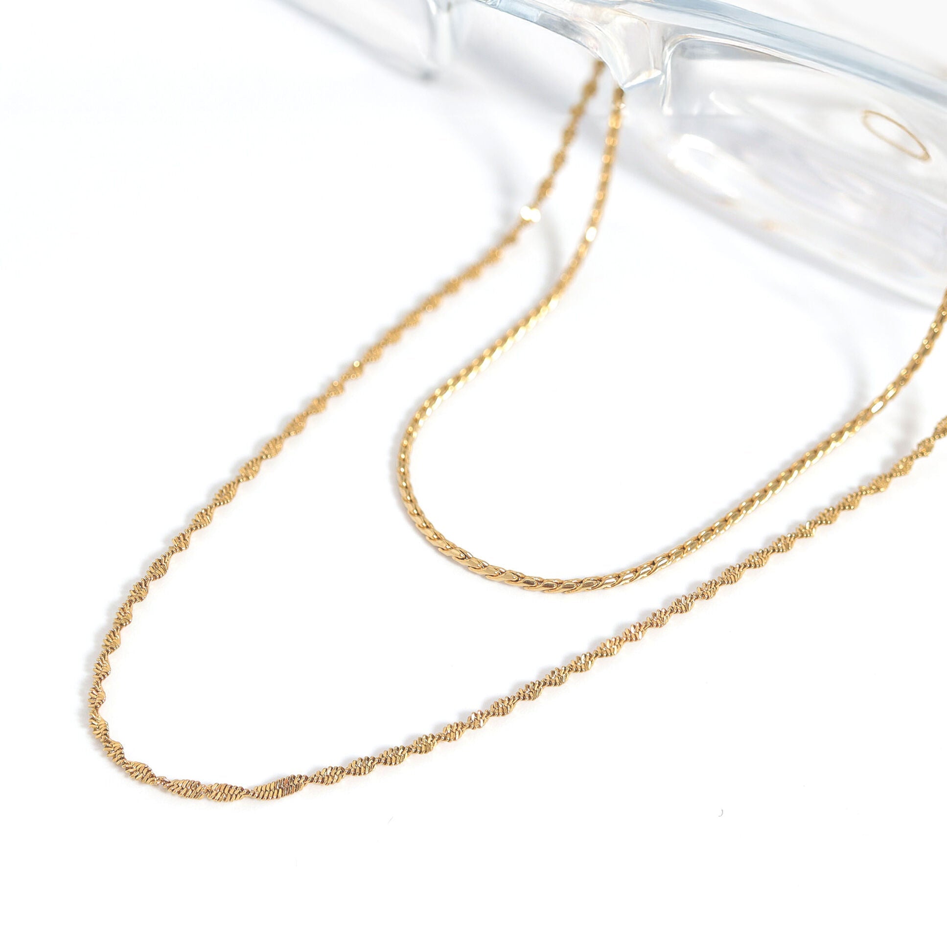 Gold chain necklace on a white background