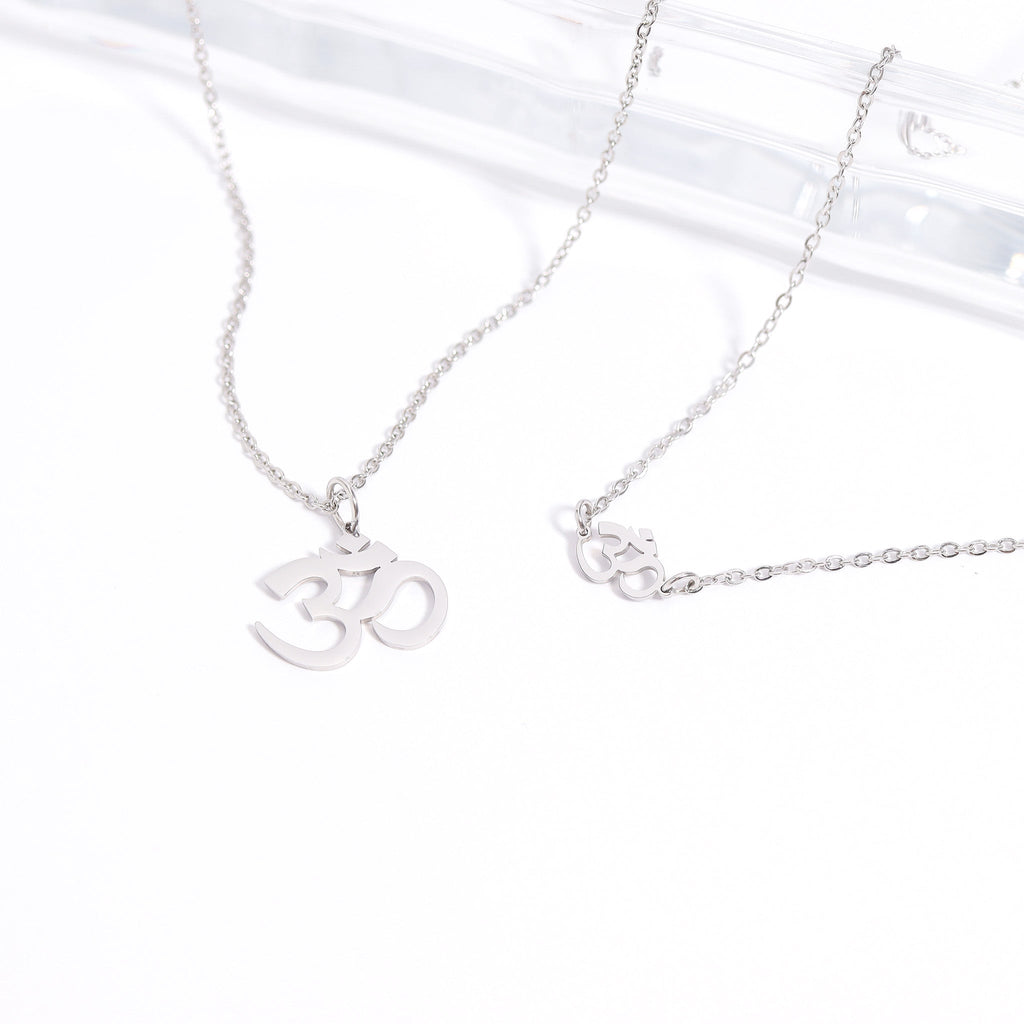 Silver necklace with Om symbol pendant on a white background