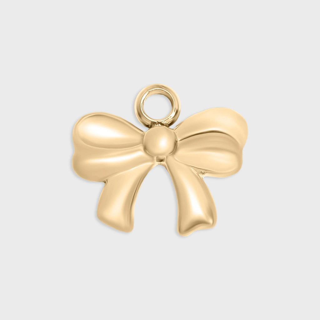 Gold bow-shaped pendant on a light gray background