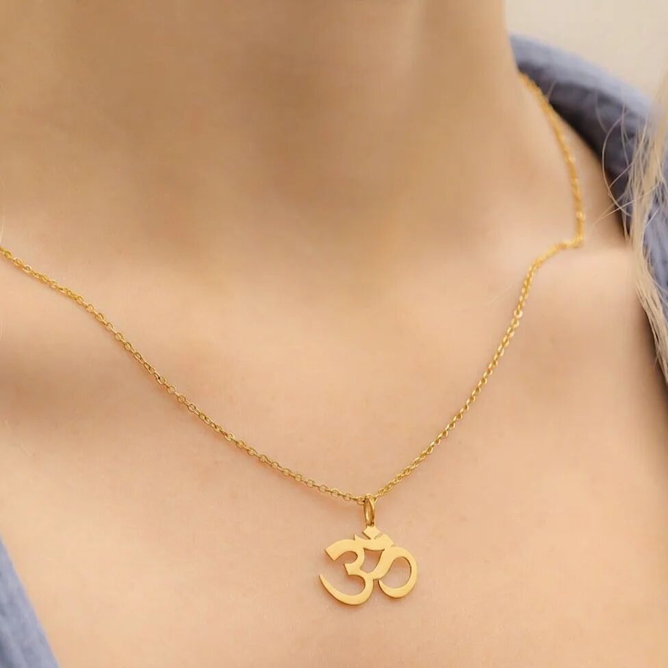 Gold necklace with Om pendant around a neck