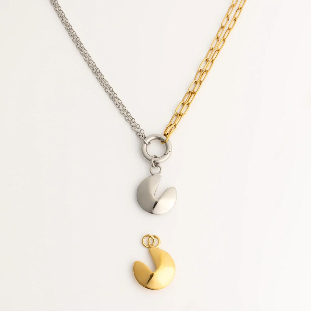 Two-toned necklace with fortune cookie pendants on a light gray background