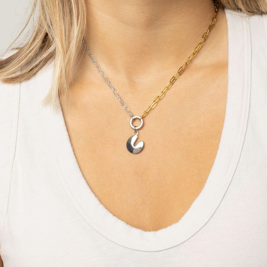 Two toned necklaces with a fortune cookie charm on a white background