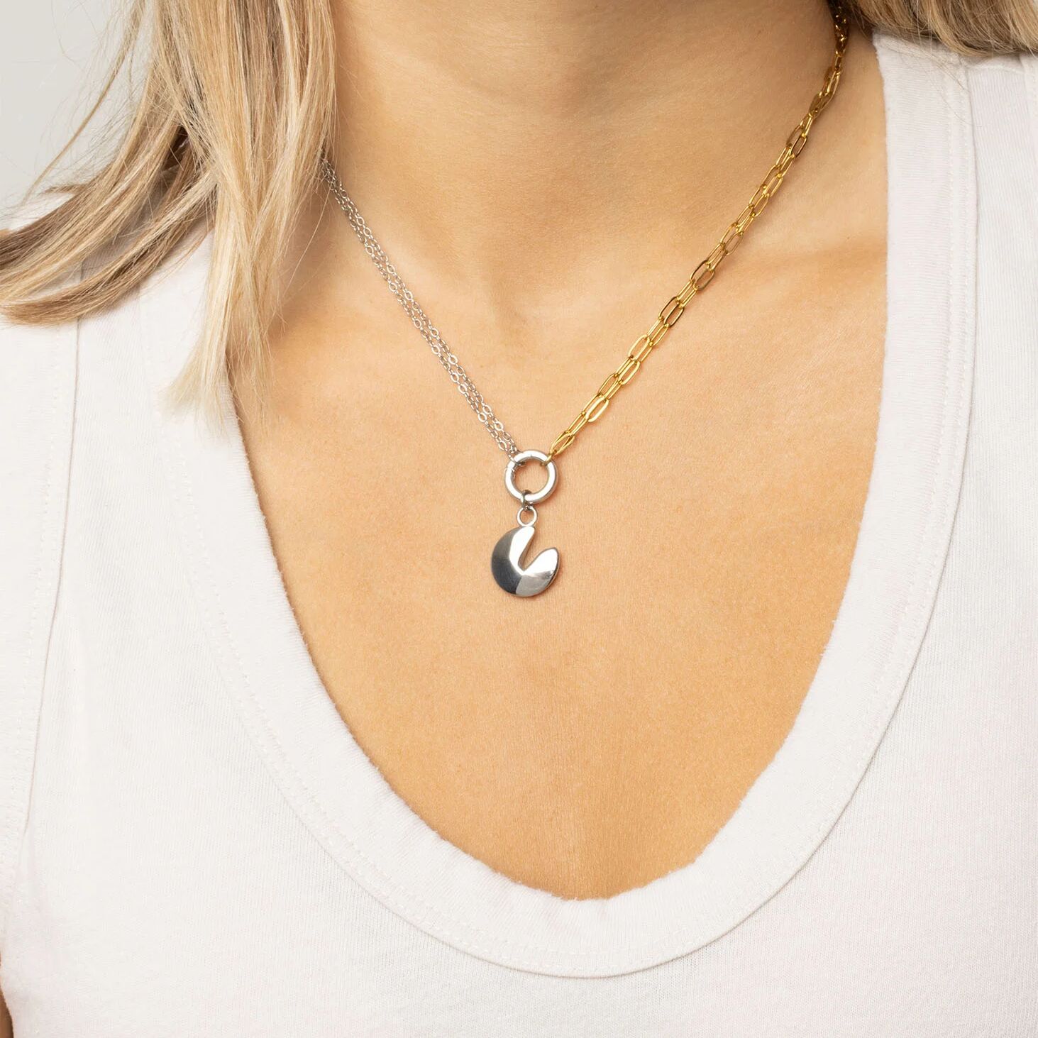 Two toned necklaces with a fortune cookie charm on a white background