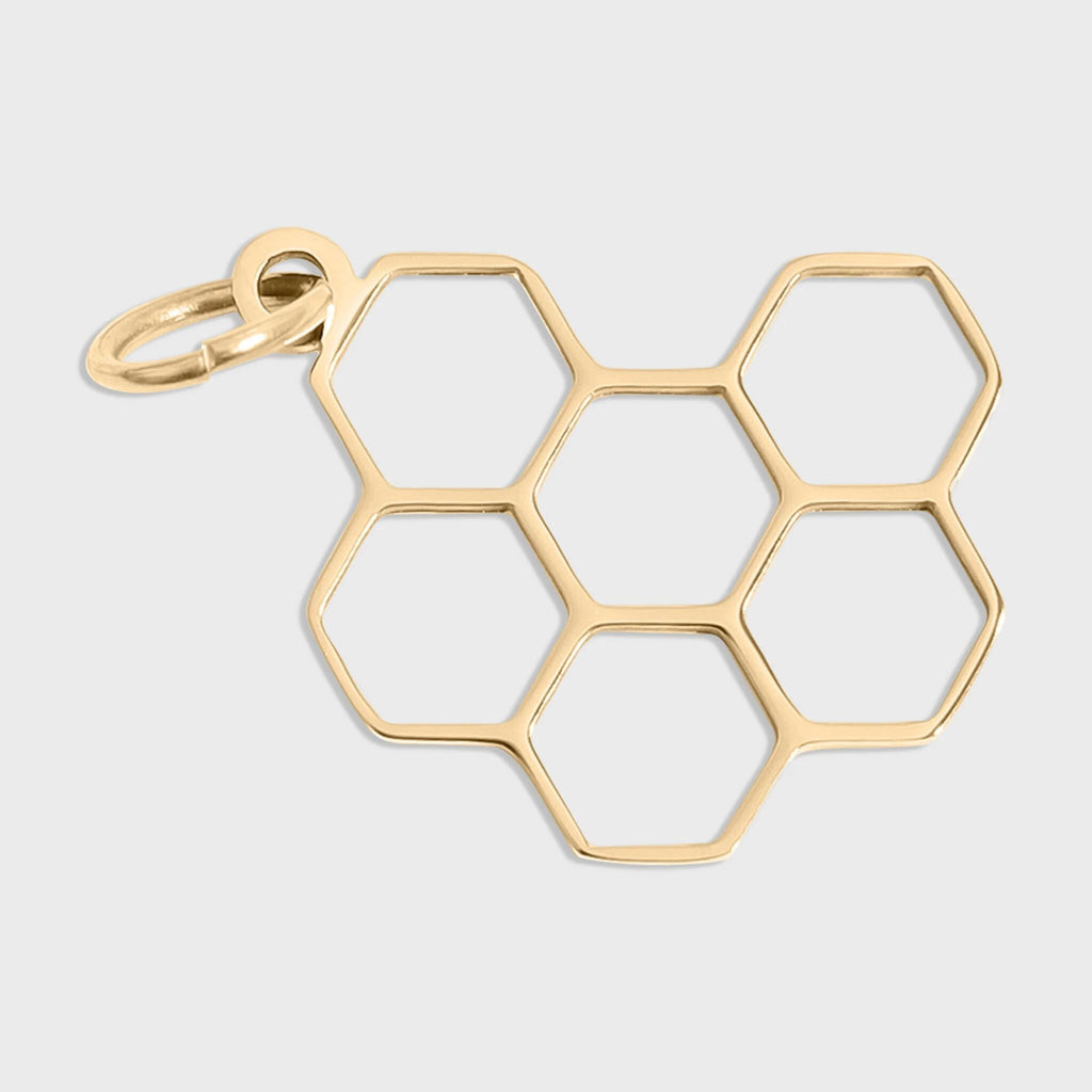 Gold honeycomb pendant on a light gray background