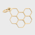 Gold honeycomb pendant on a light gray background