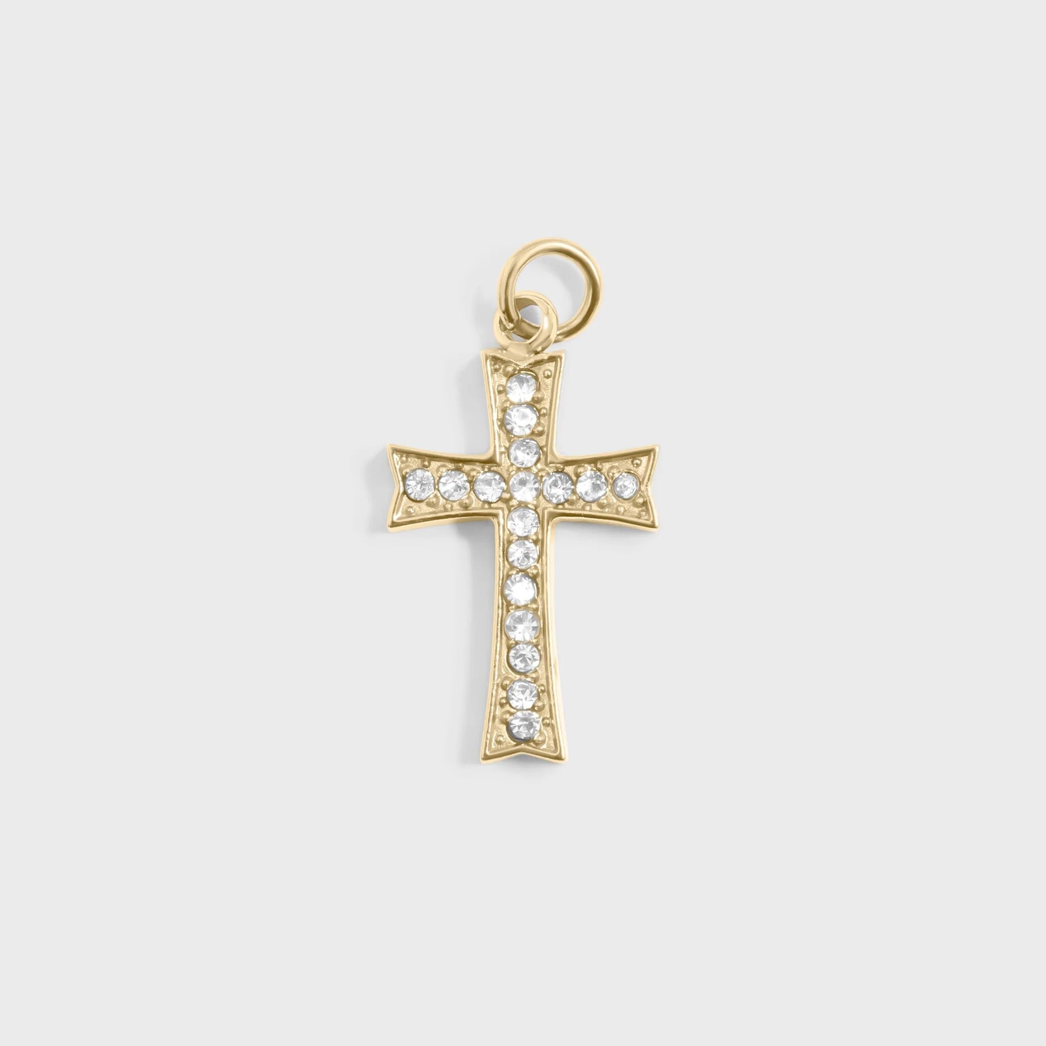 Gold cross pendant with clear stones on a light gray background