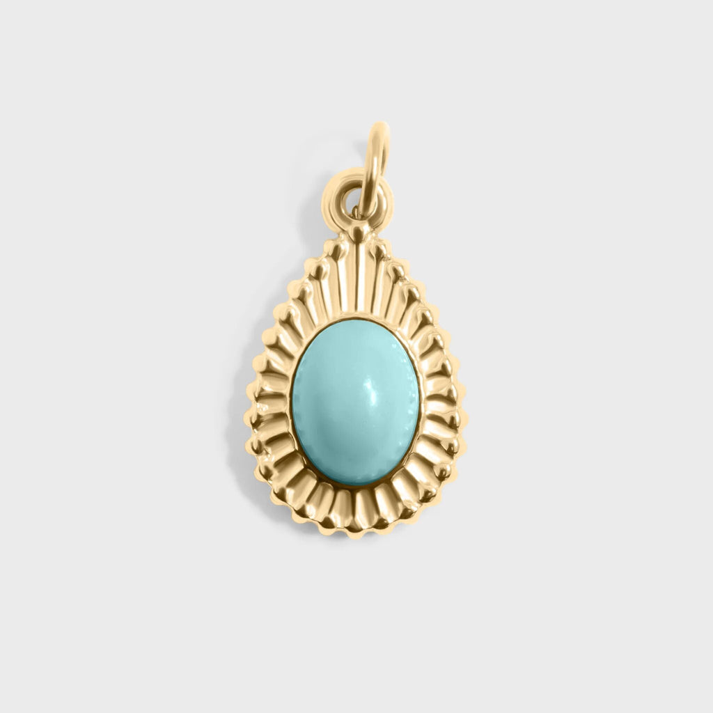 Gold pendant with a turquoise stone on a light gray background