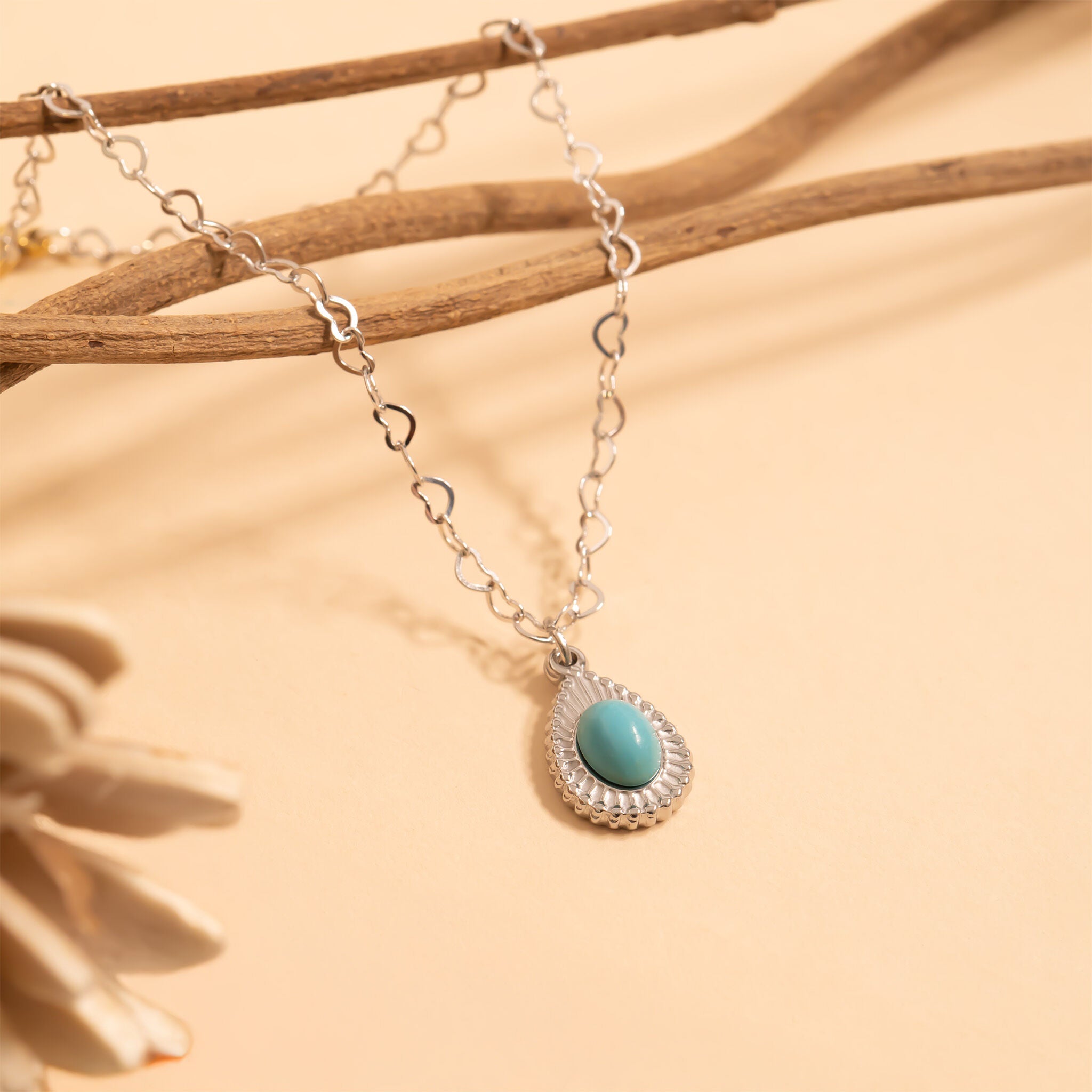 Necklace with a turquoise pendant on a beige background