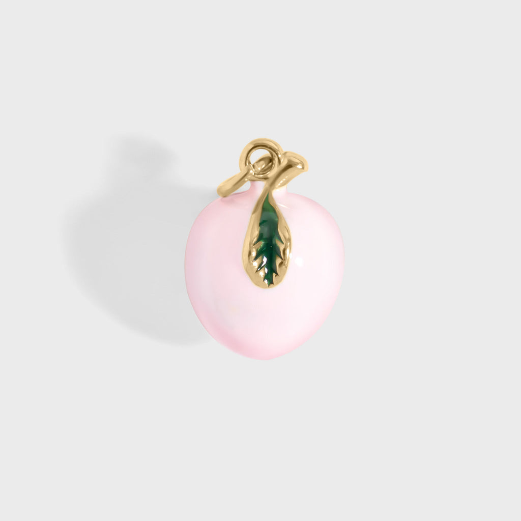 Pink peach pendant with gold and green accents on a light gray background