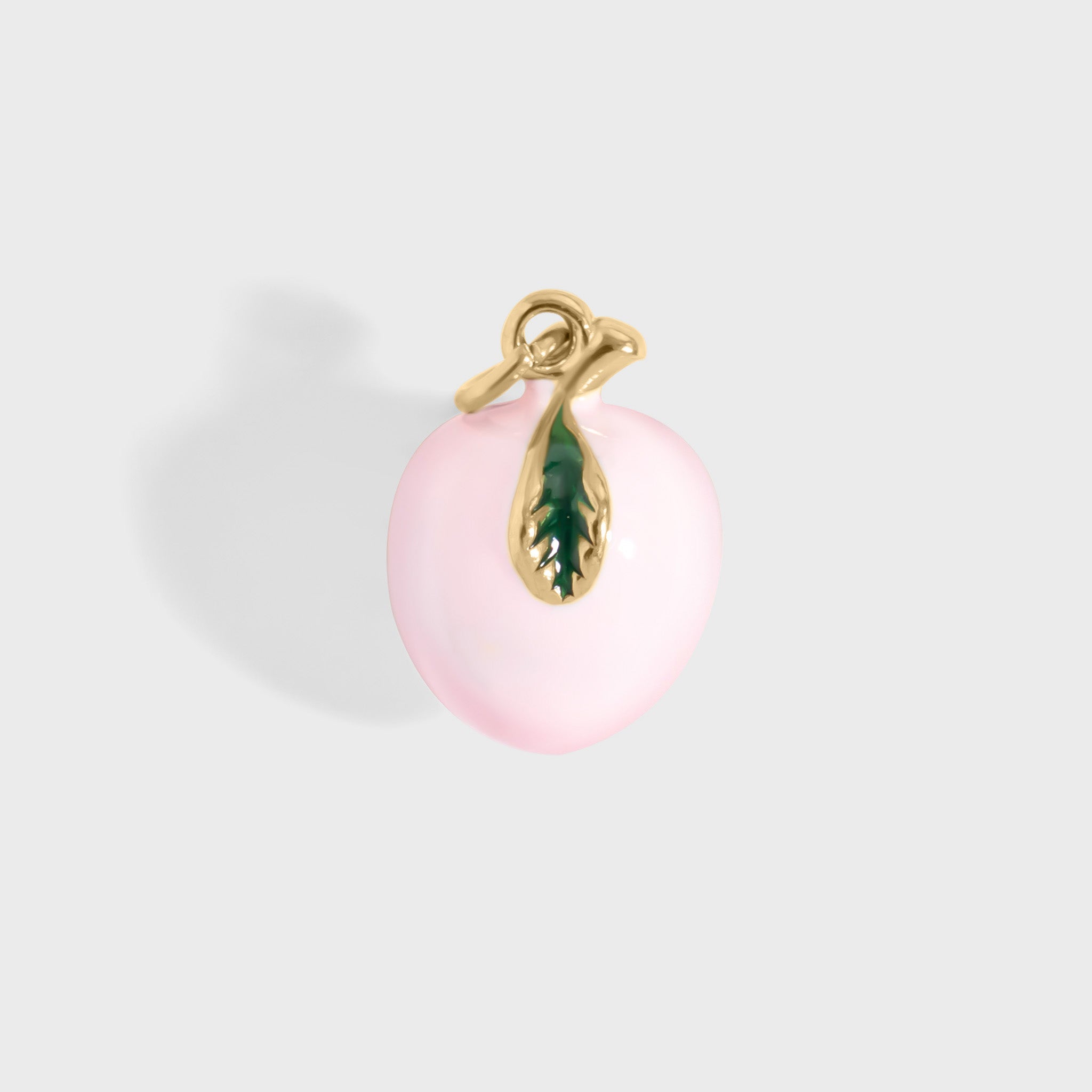 Pink peach pendant with gold and green accents on a light gray background