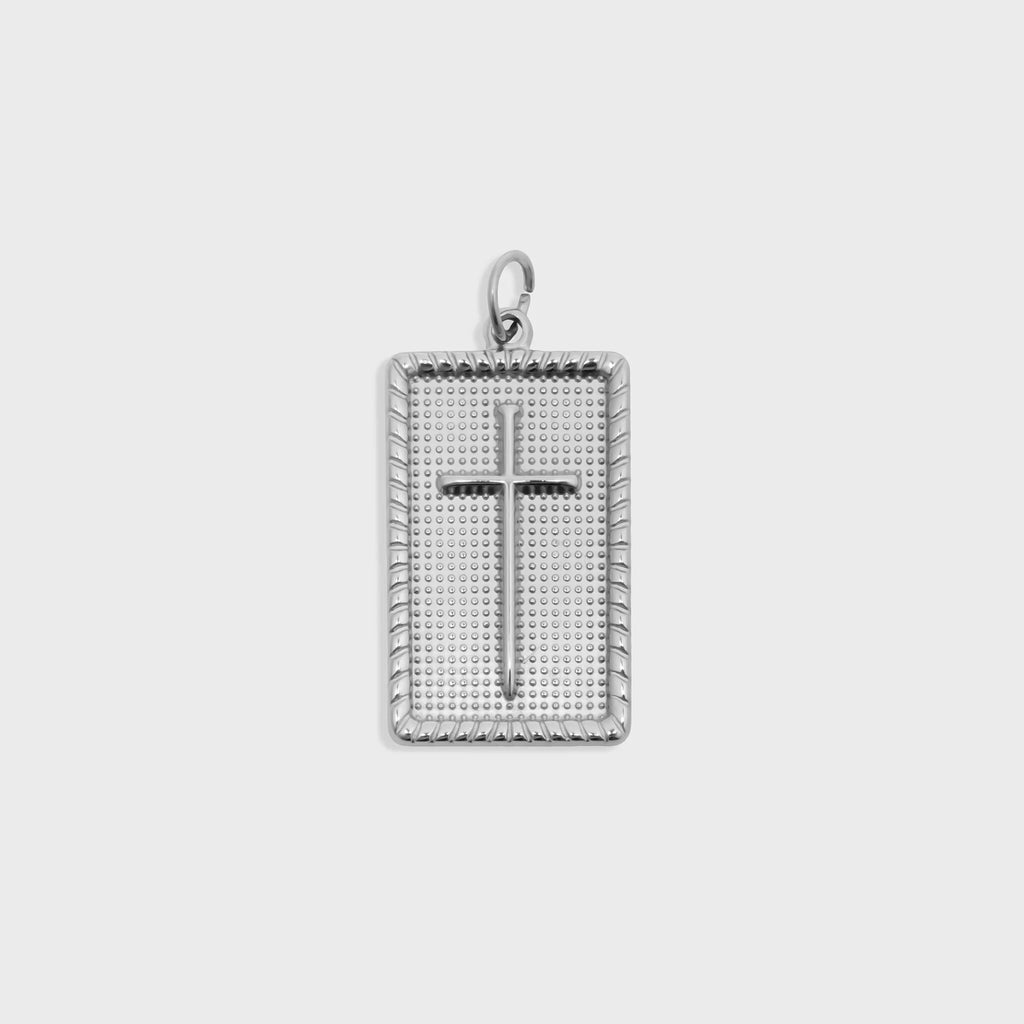 Silver cross pendant on a white background