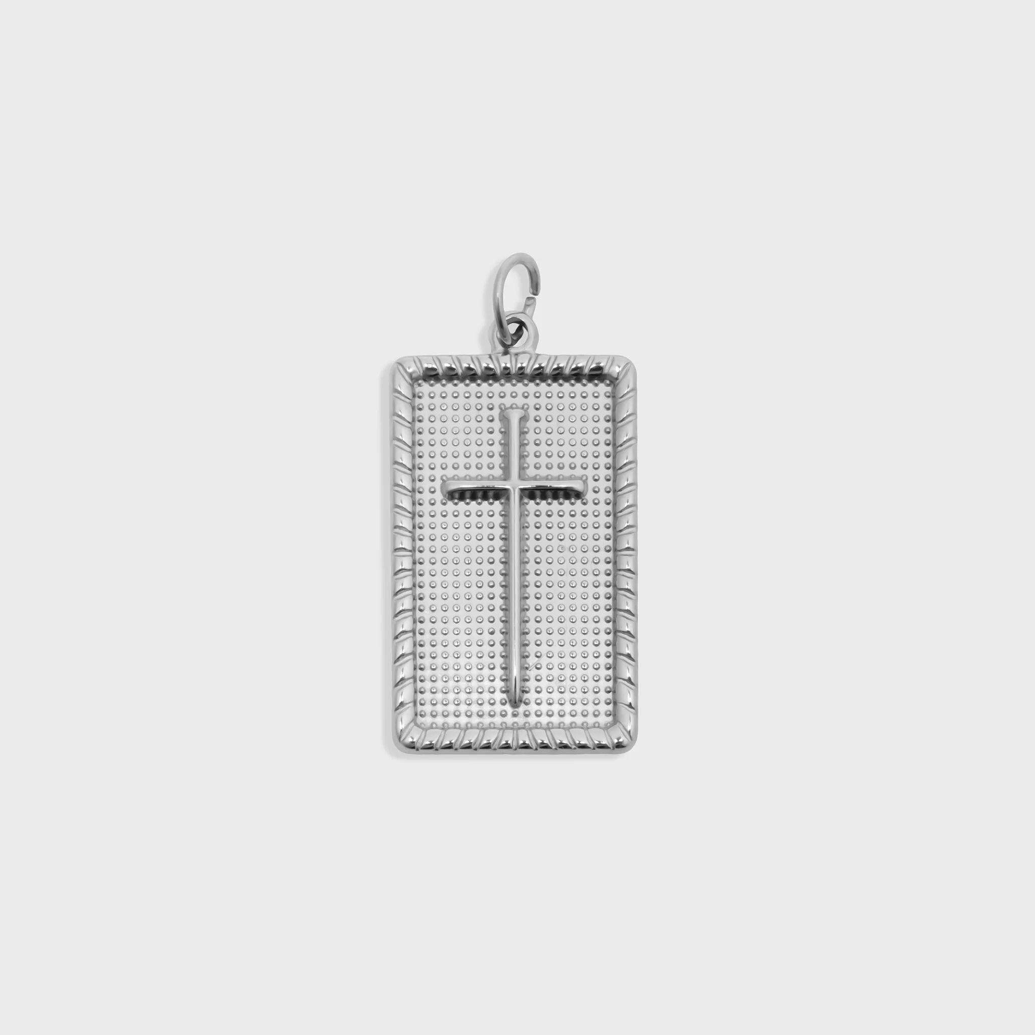 Silver cross pendant on a white background