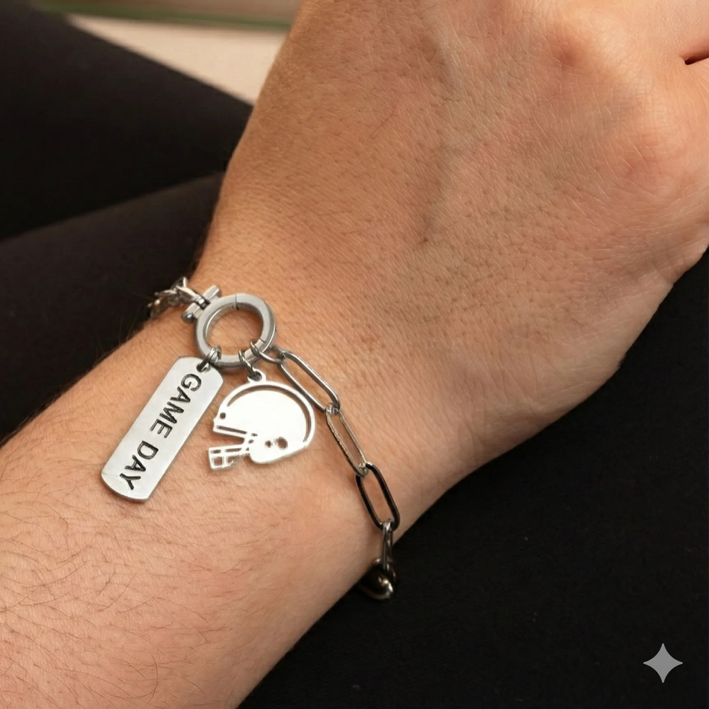 Silver bracelet with 'GAME DAY' charm on a wrist against a black background