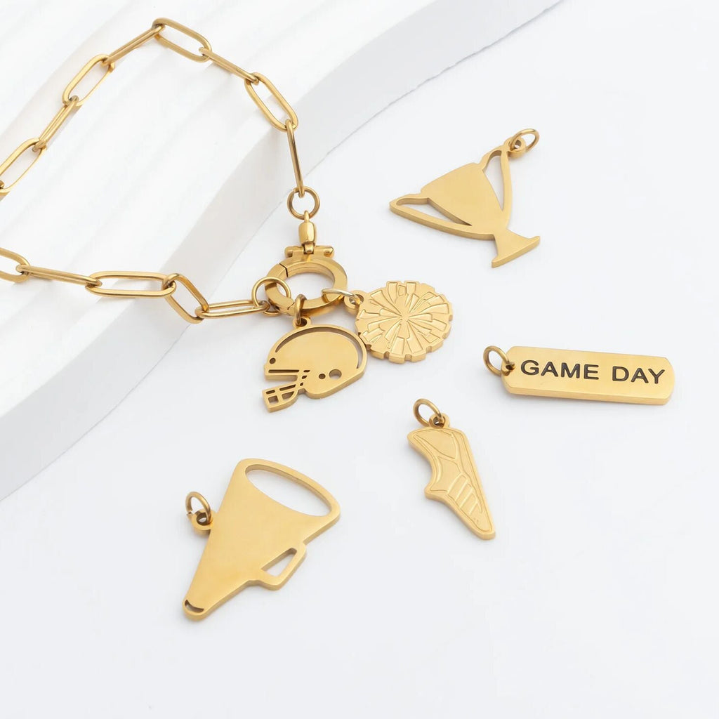 Gold bracelet with various charms on a white background