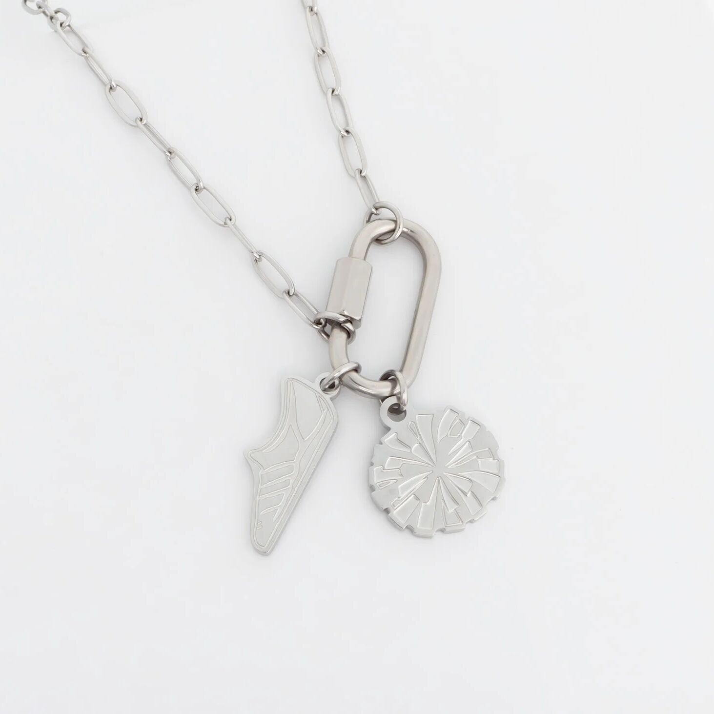 Silver necklace with two pendants on a white background