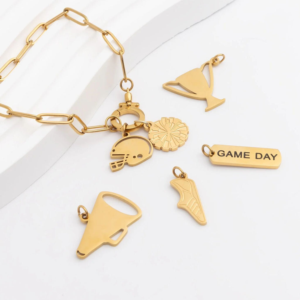 Gold bracelet with various charms on a white background