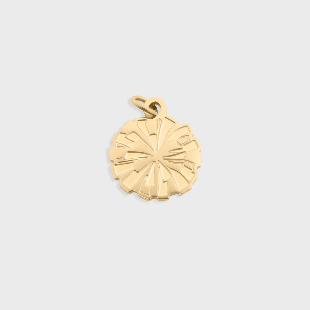 Gold pendant on a light gray background