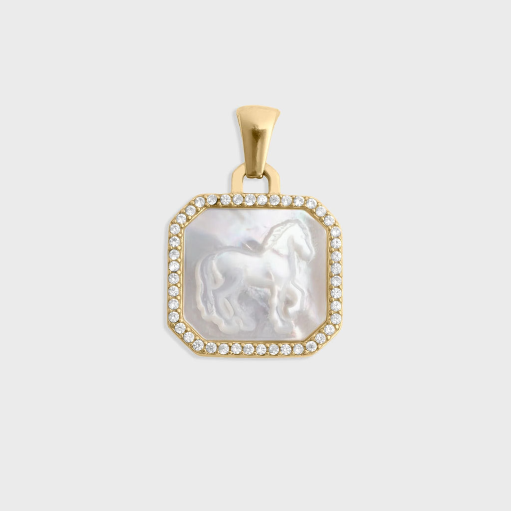 Gold pendant with a central stone featuring a horse design on a light gray background