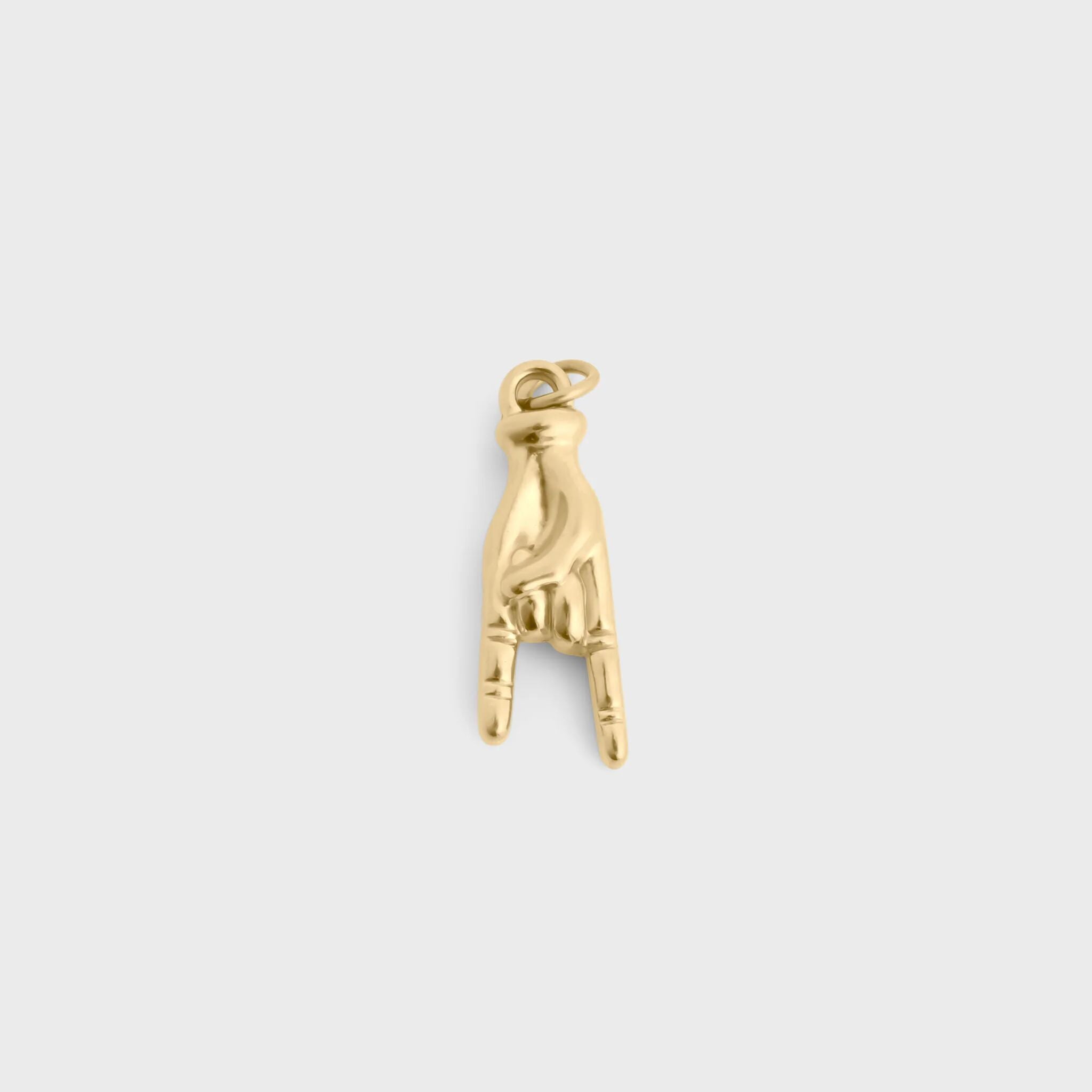 Gold and white beaded charm on a light gray background