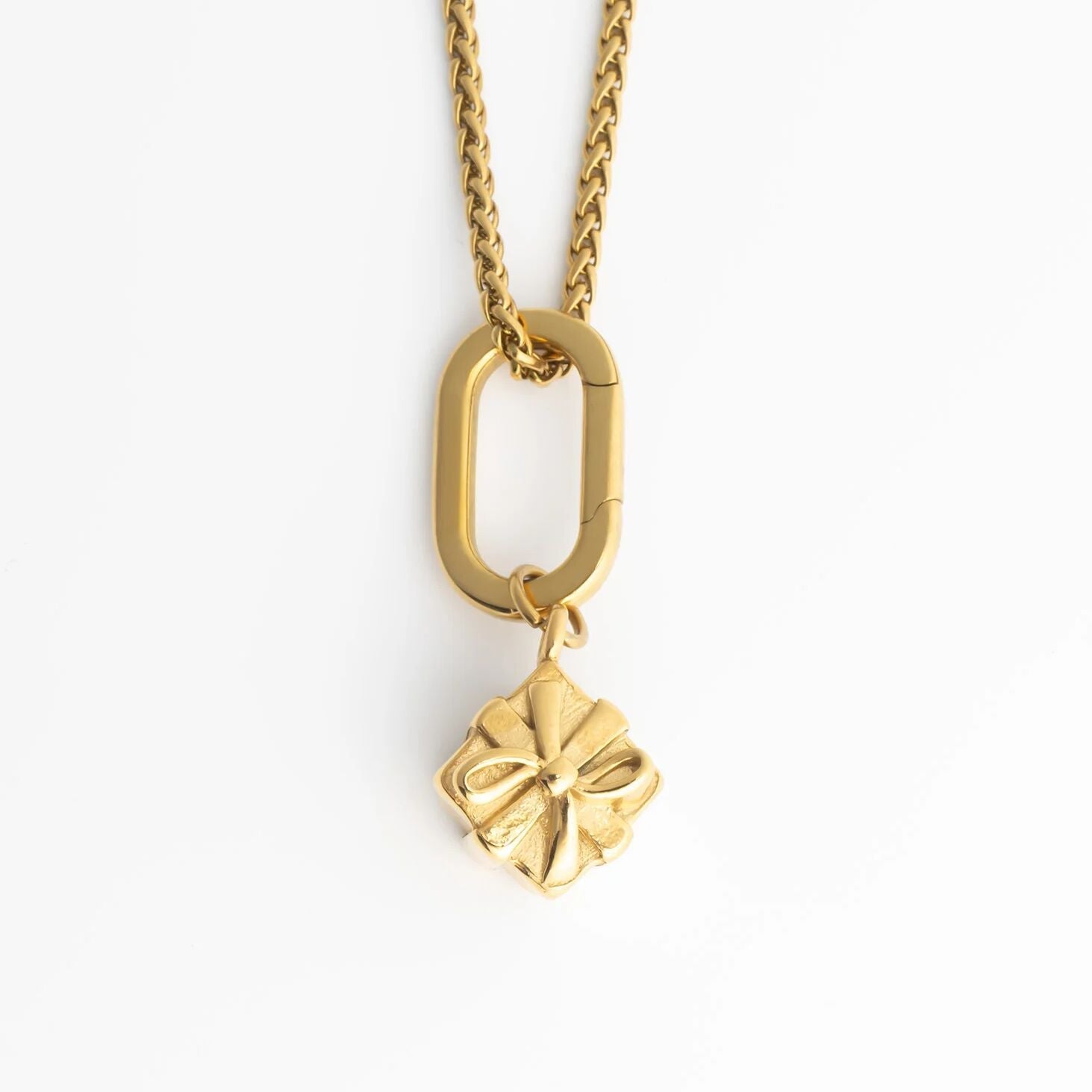 Gold necklace with a Present Charm on a white background