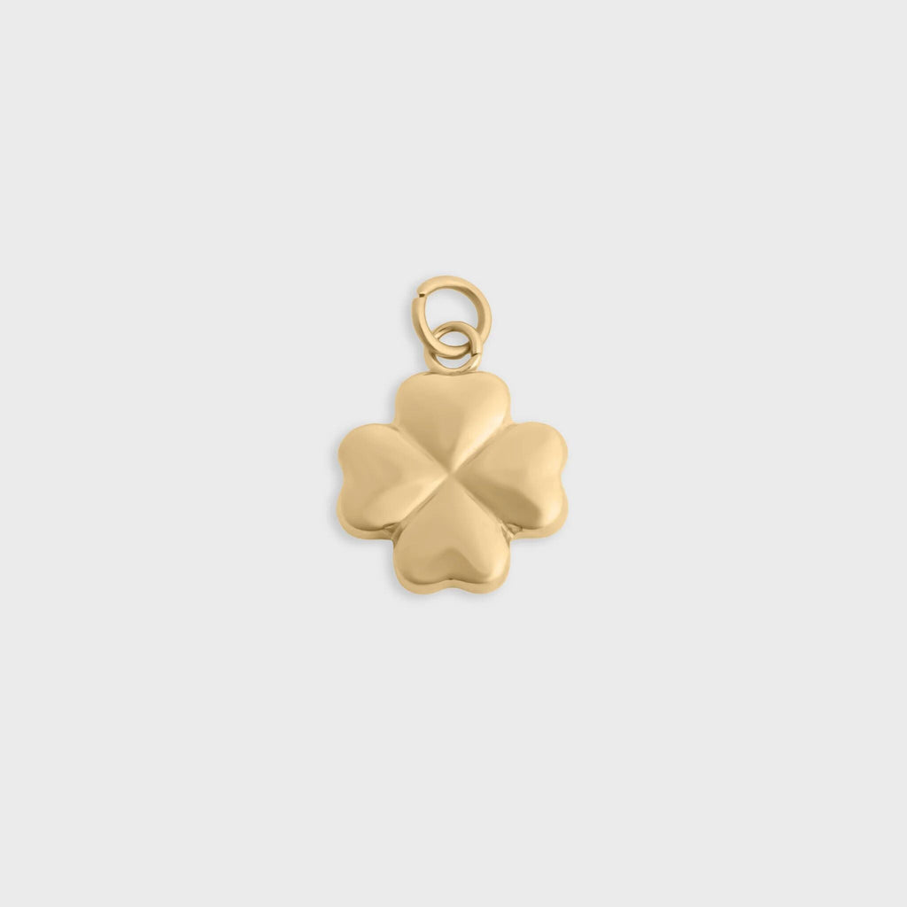 Gold four-leaf clover pendant on a light gray background