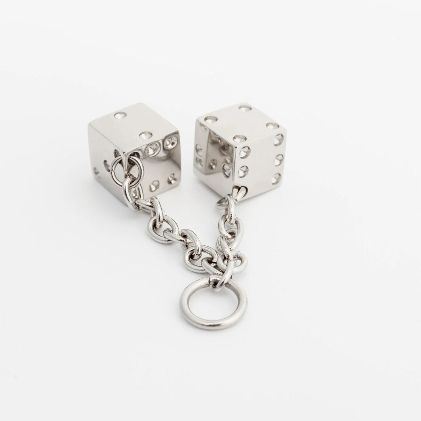 Silver dice-shaped pendant with a chain on a white background