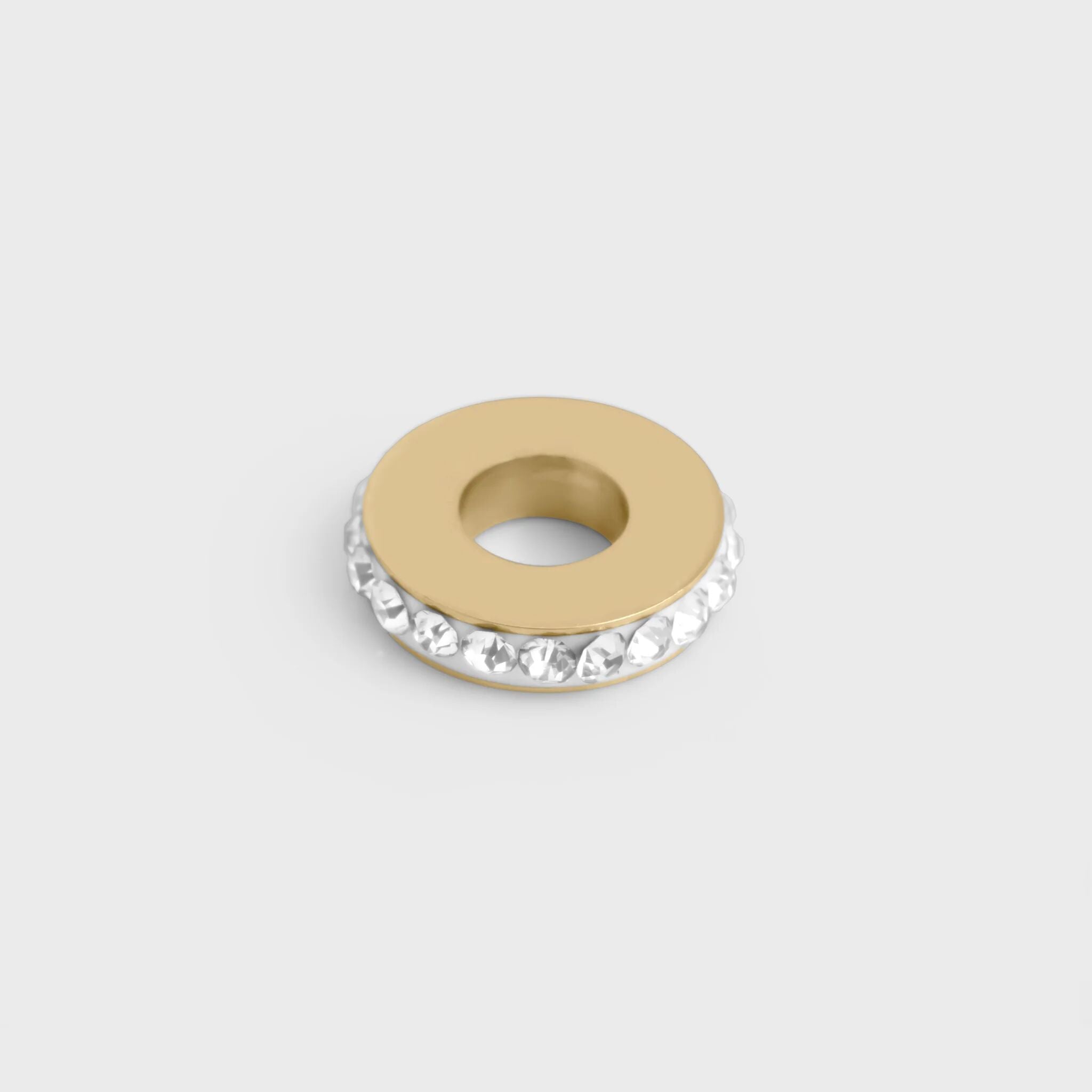 Gold spacer beads with crystal embellishments on a light gray background