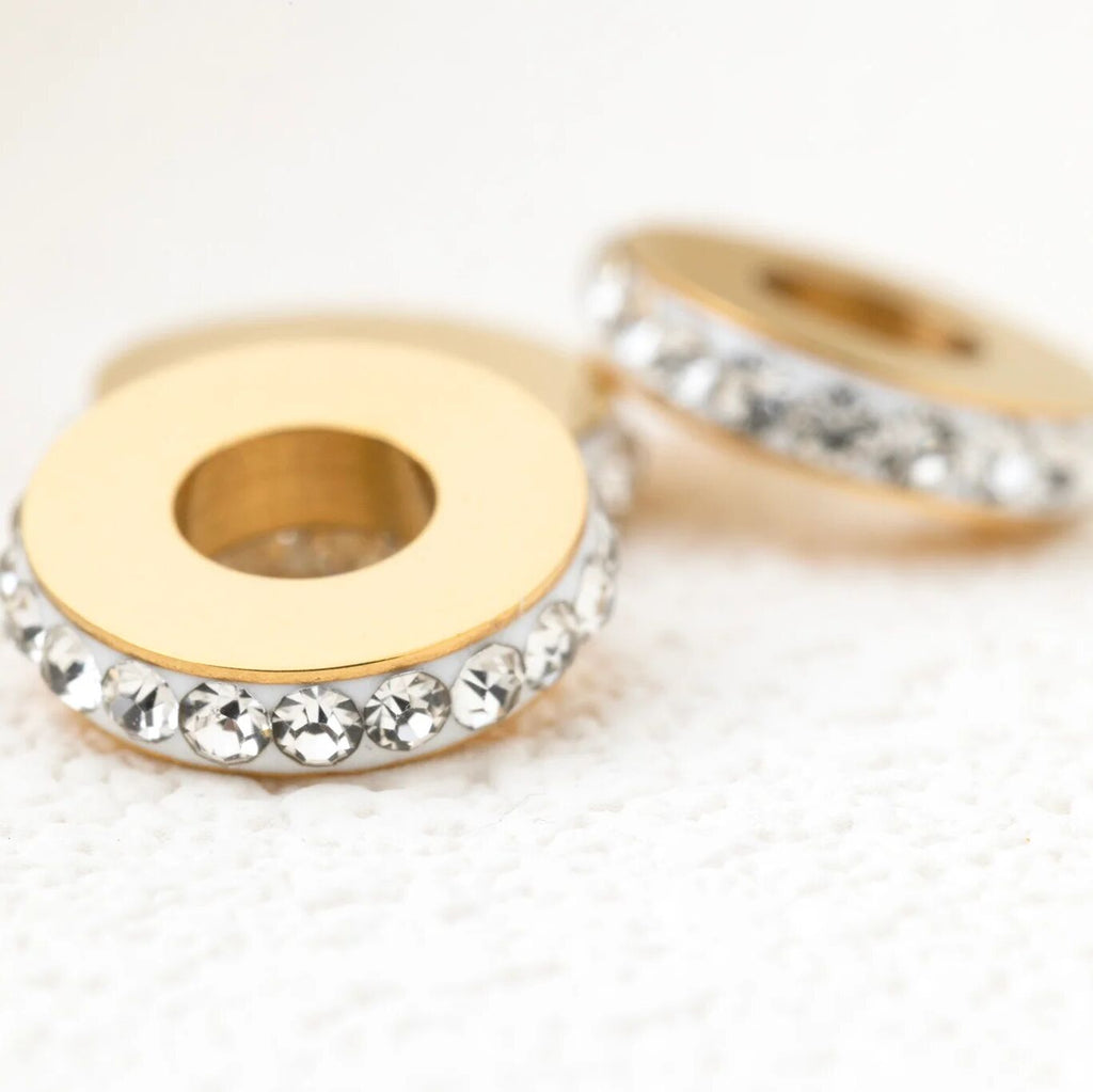 Gold spacer beads on a white background