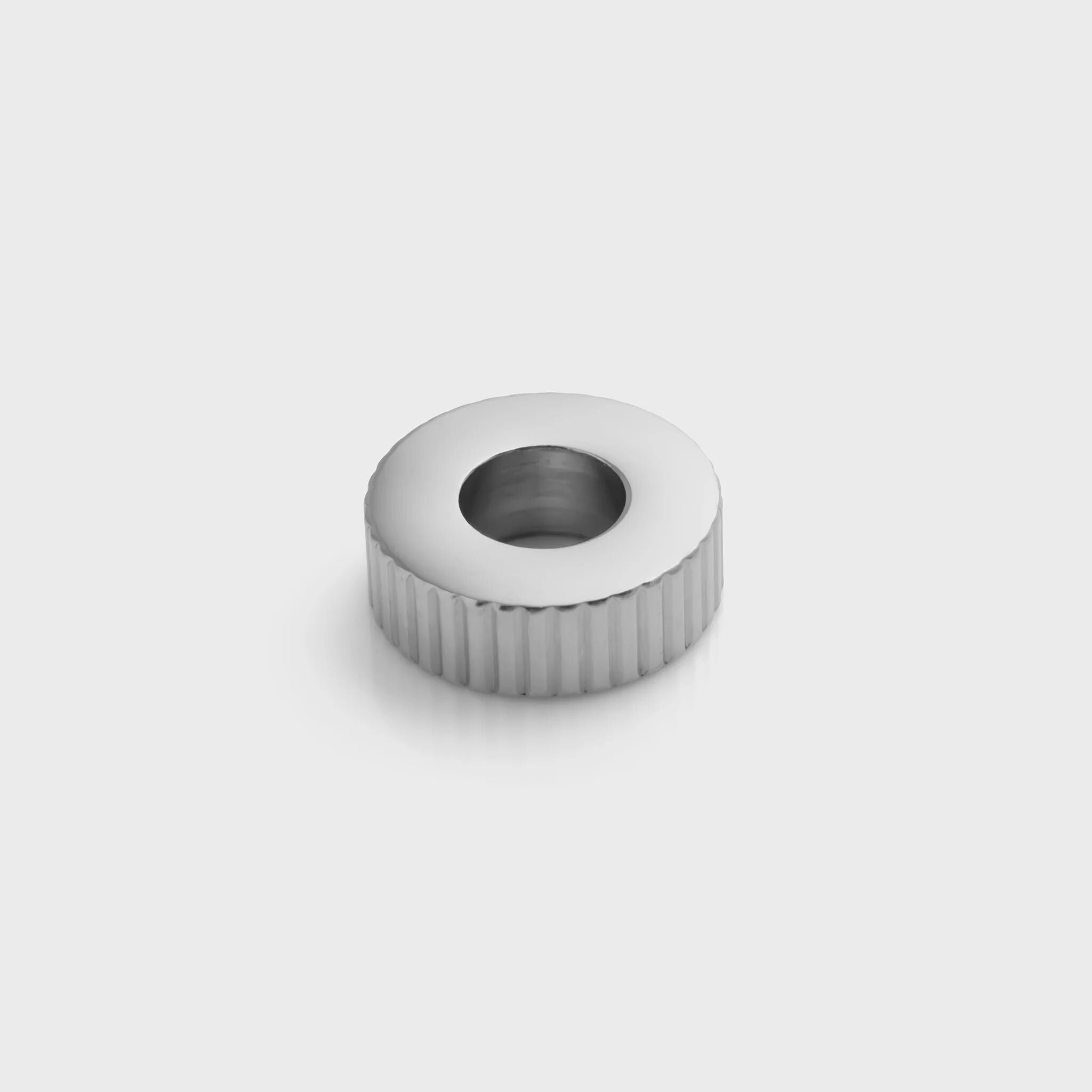 Silver fluted spacer beads on a light gray background