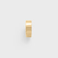 Gold spacer bead on a light gray background