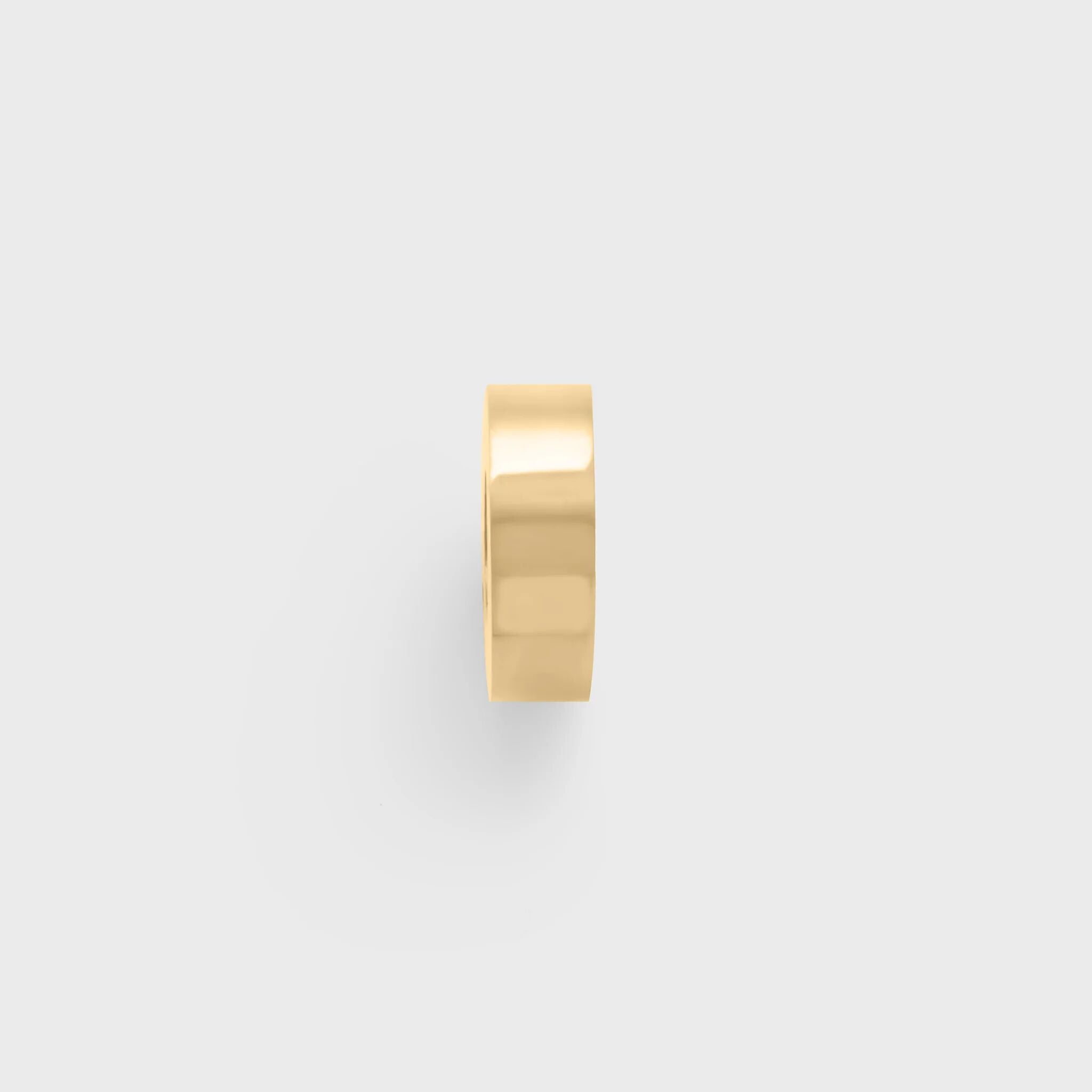 Gold spacer bead on a light gray background