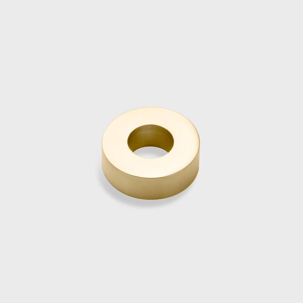 Gold spacer bead on a light gray background