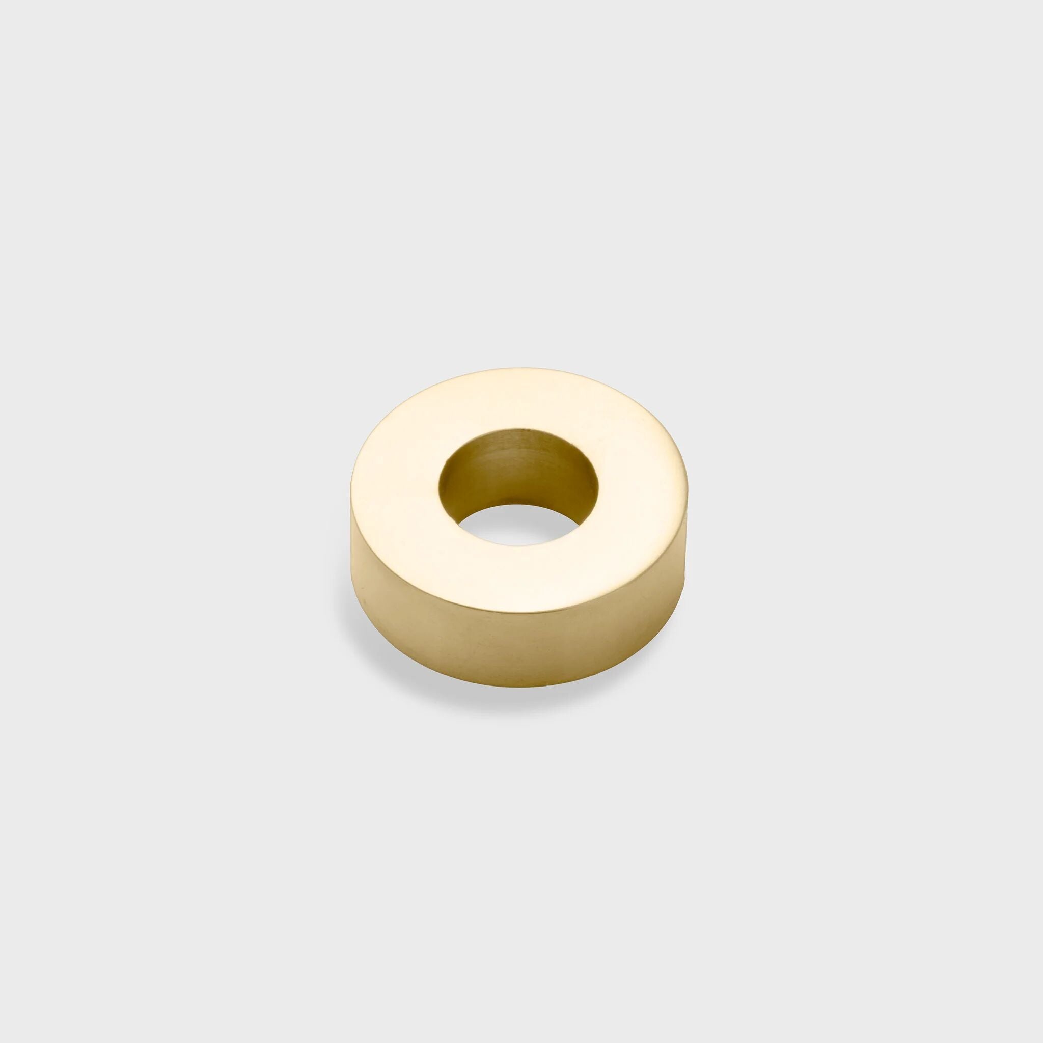 Gold spacer bead on a light gray background