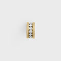 Gold spacer bead with embedded crystals on a light gray background