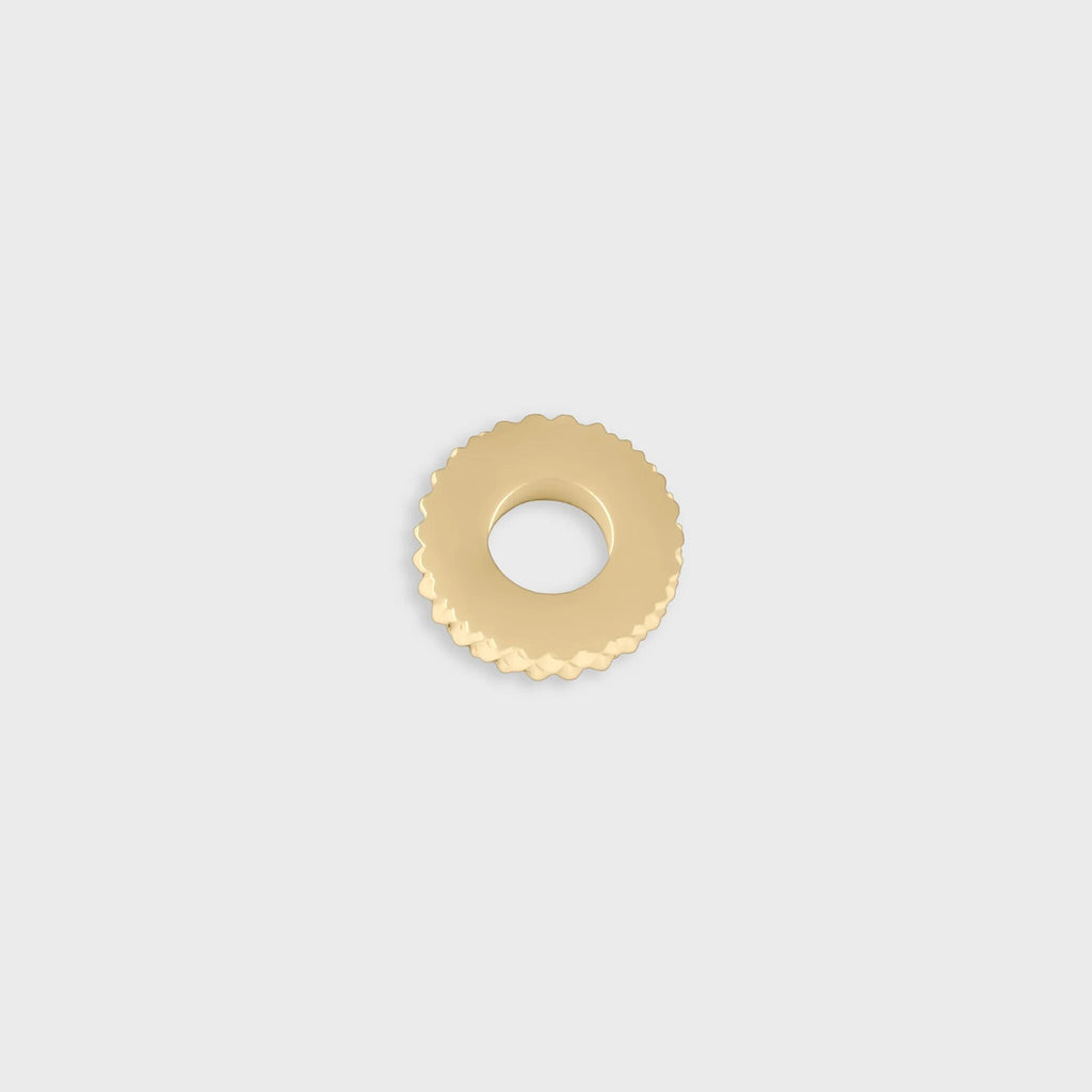 Gold textured spacer bead on a light gray background