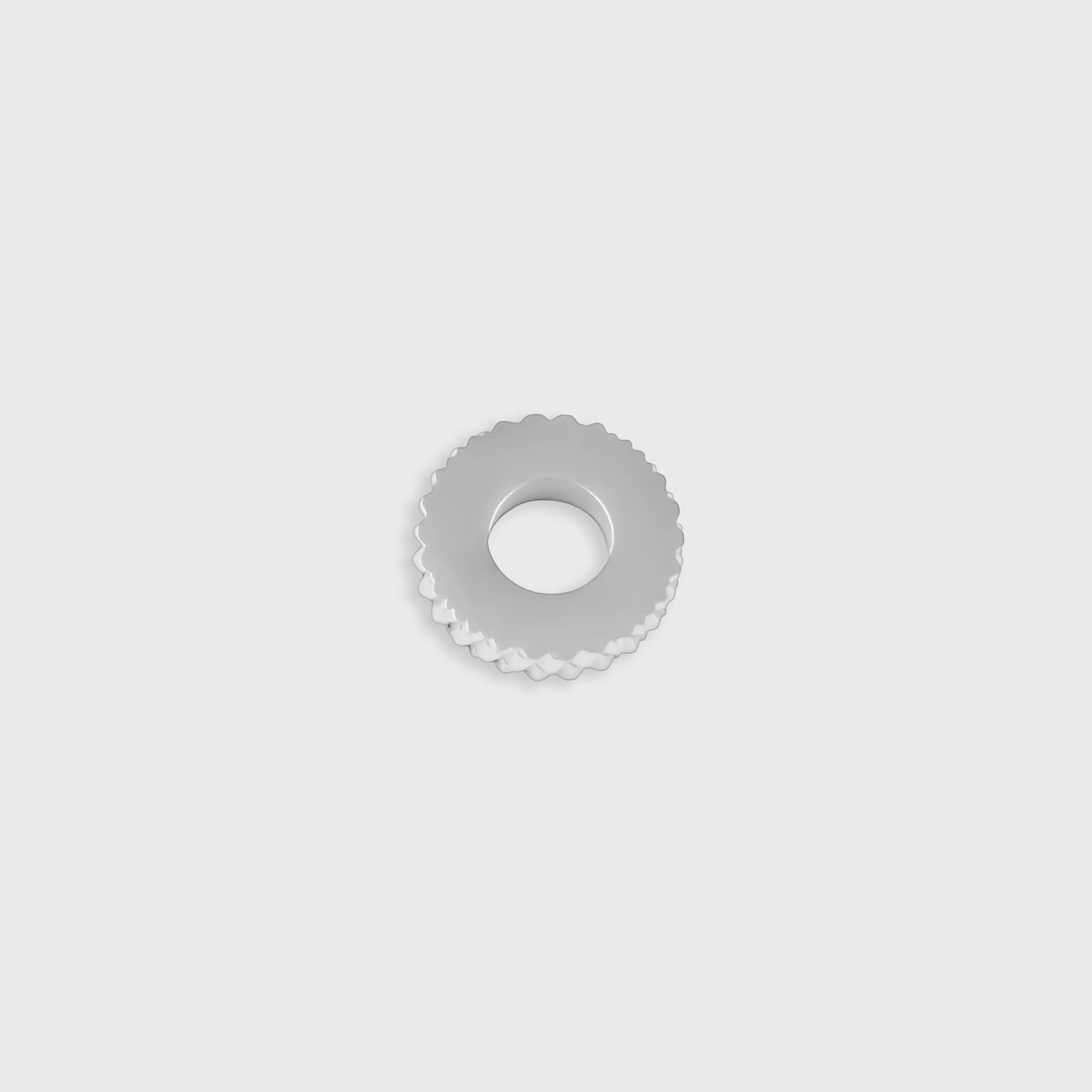 Silver textured spacer bead on a light gray background