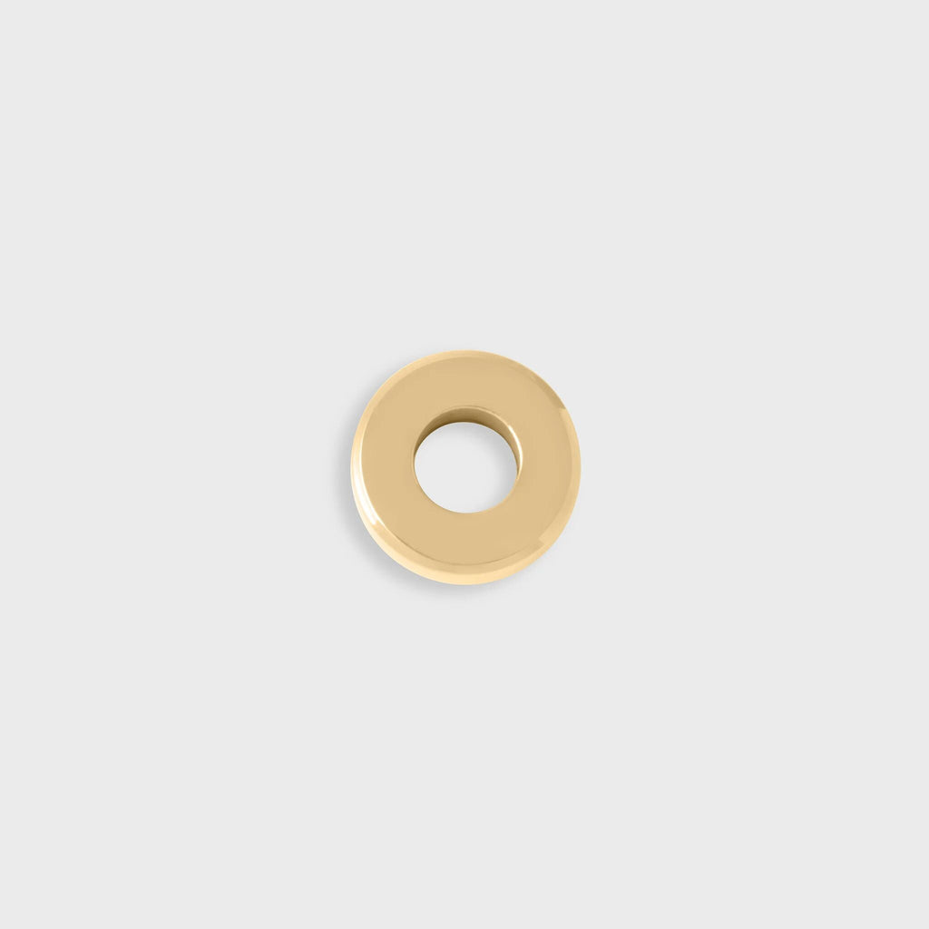 Gold spacer bead on a light gray background