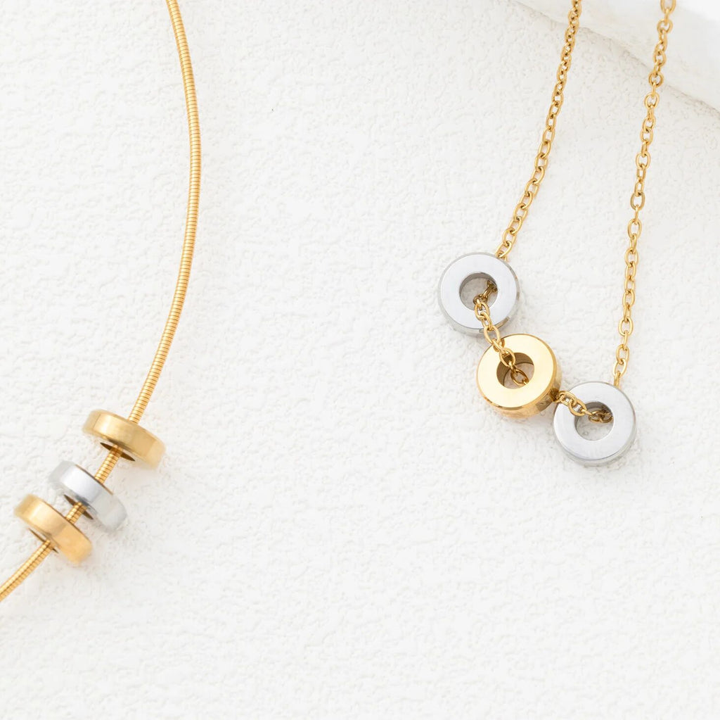 Gold and silver necklace with spacer beads on a white background