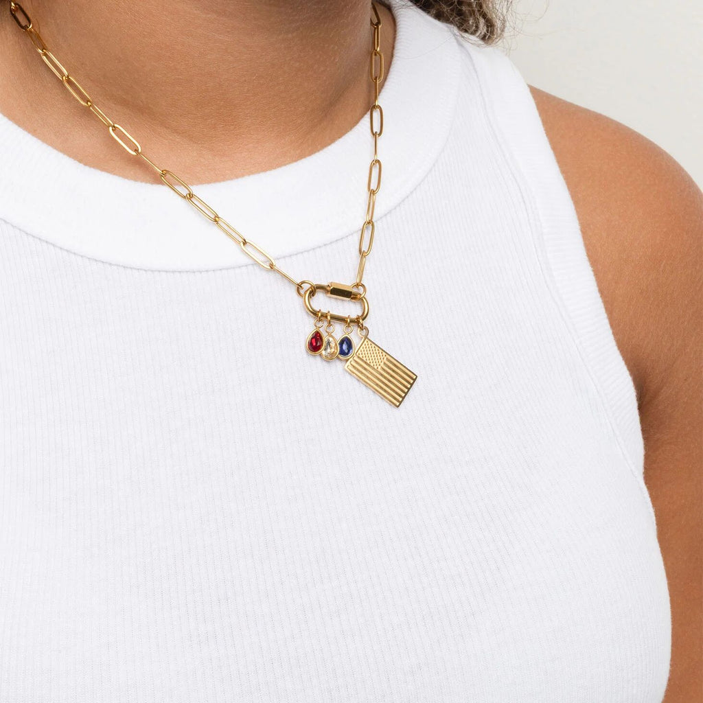 Gold chain necklace with charms on a white background