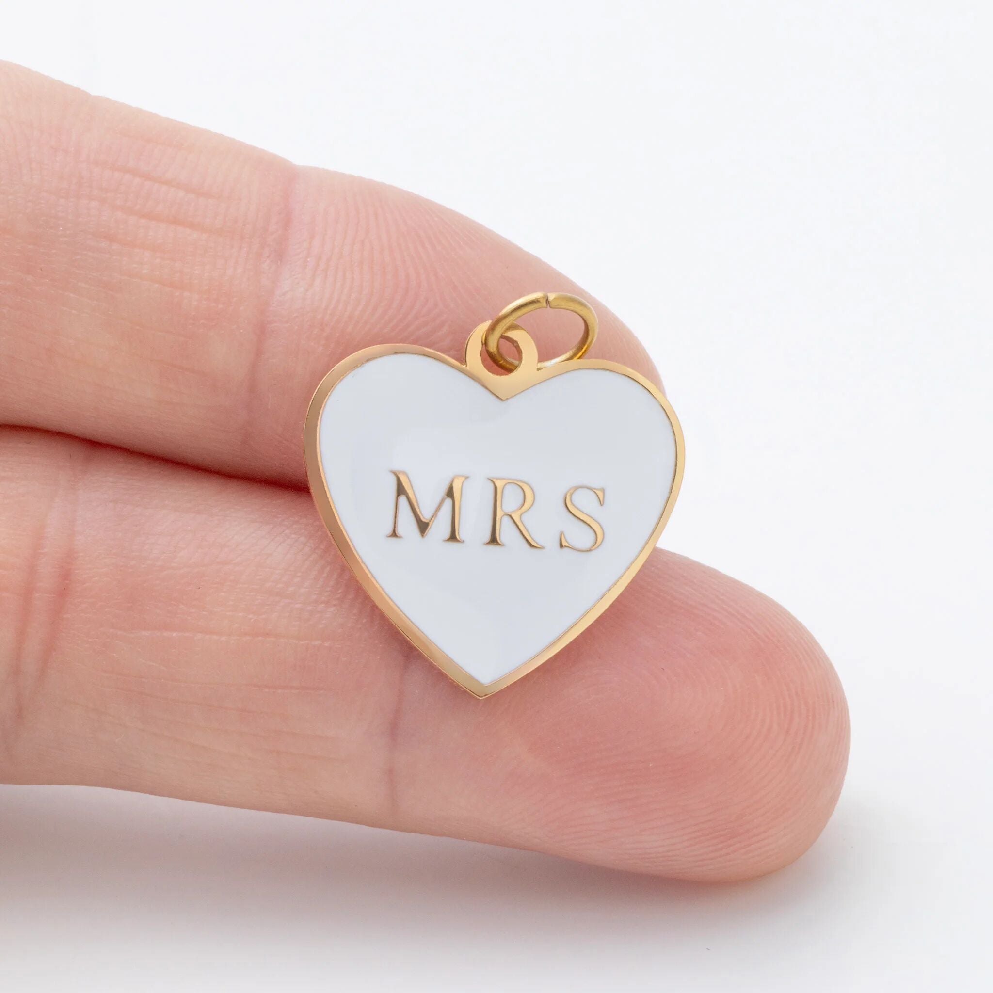 Heart-shaped pendant with 'MRS' on a white background