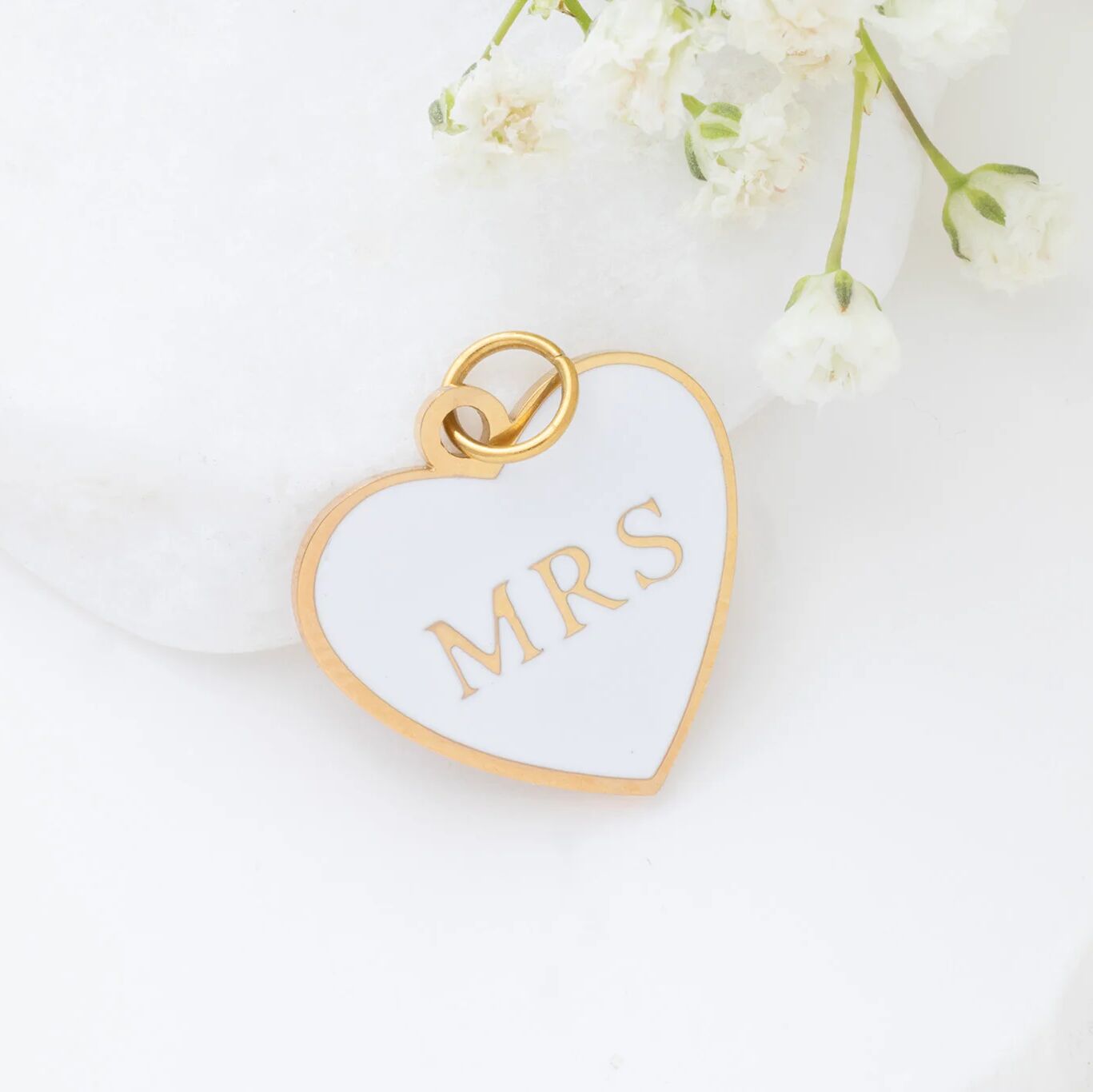 Heart-shaped pendant with 'MRS' on a white background