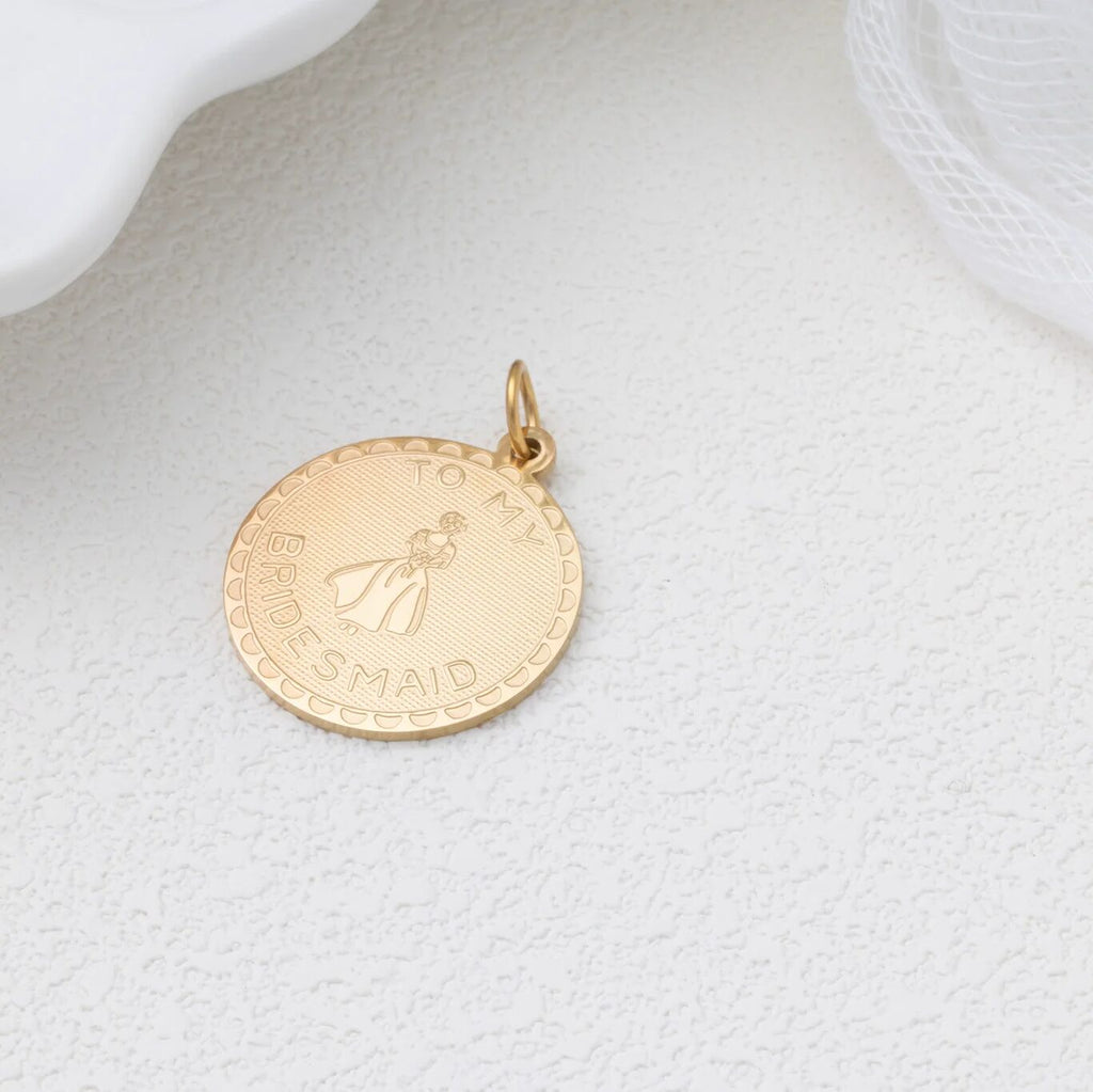 Gold pendant with 'To My Bridesmaid" text on a light gray background