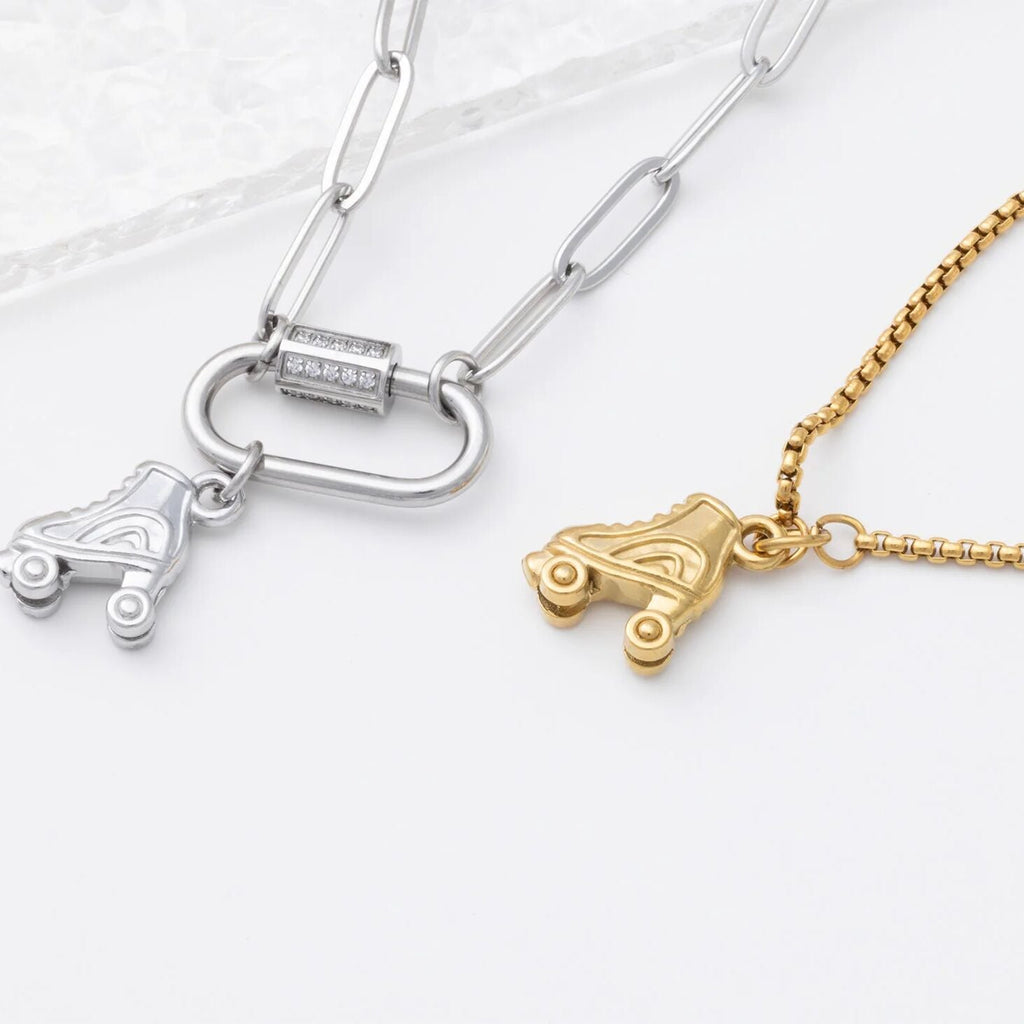 Two necklaces with roller skate charms on a white background
