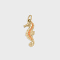 Gold seahorse pendant with coral-colored stripe on a light gray background